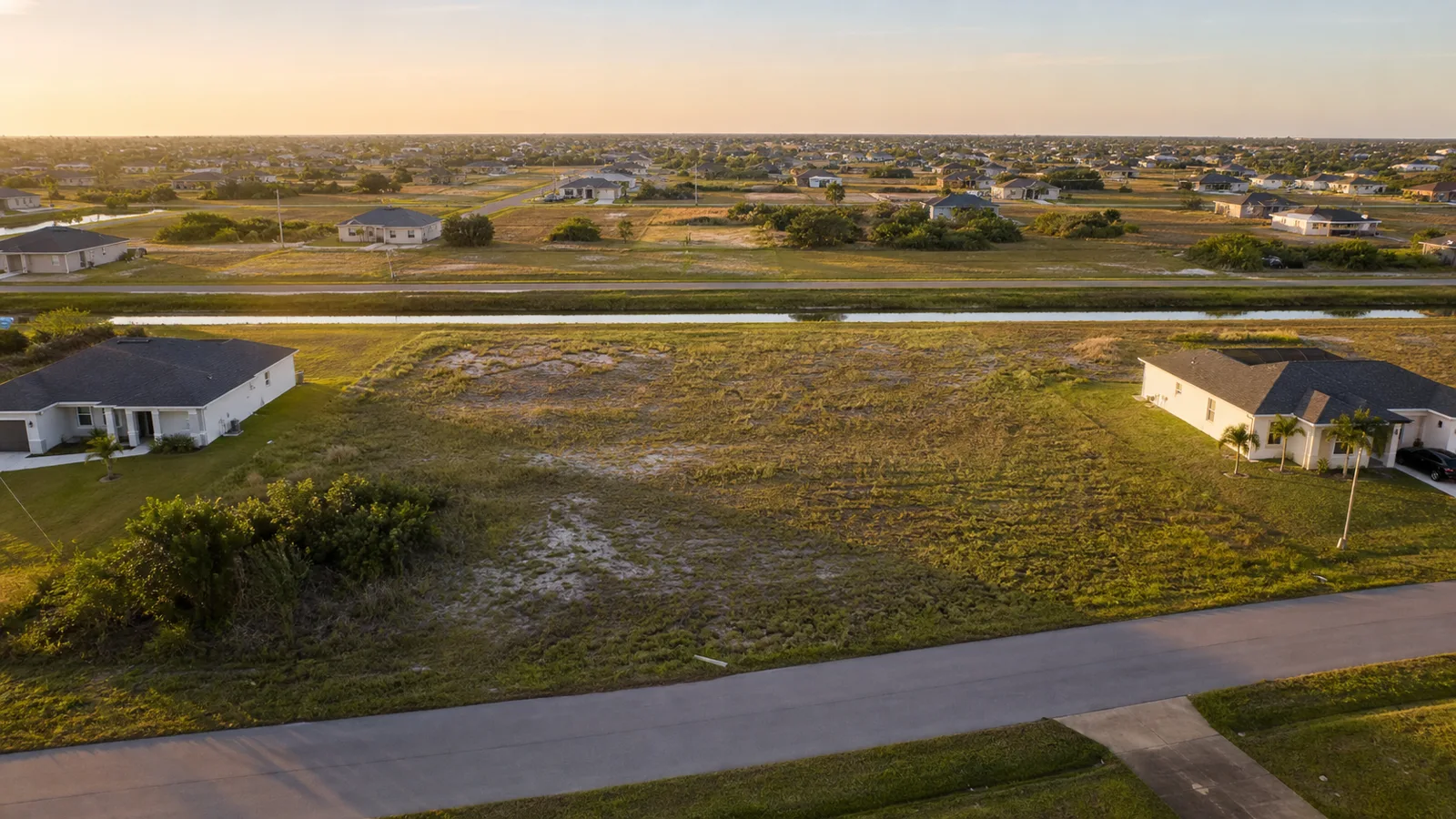 Aerial view of a vacant residential infill parcel surrounded by homes in Southwest Florida